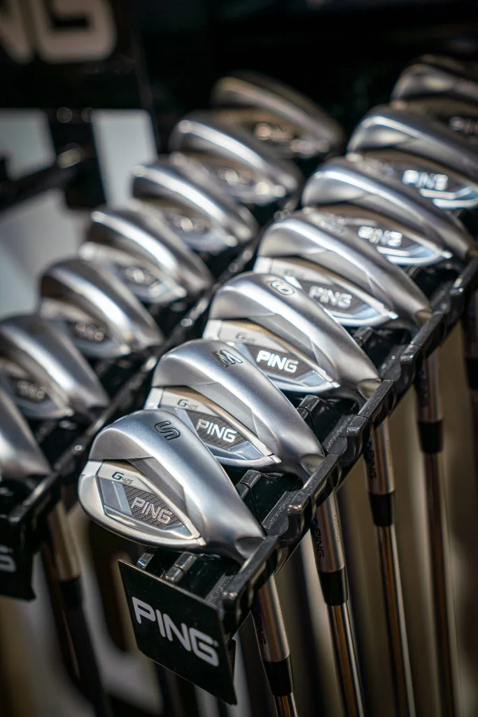 Rows of golf irons displayed in the pro golf shop at The Shropshire Golf Club in Telford, featuring golf equipment and golf club fitting in Telford