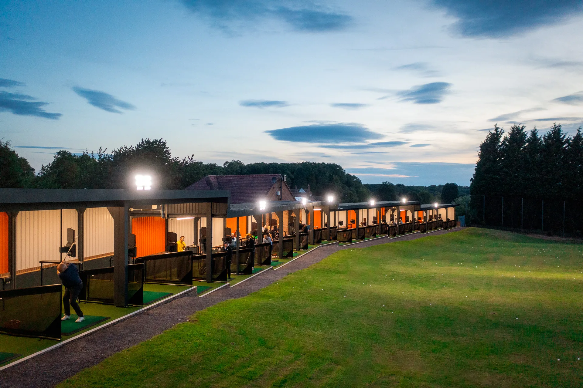TrackMan driving range Shropshire illuminated at night, offering virtual golf and family golf range experiences at The Shropshire