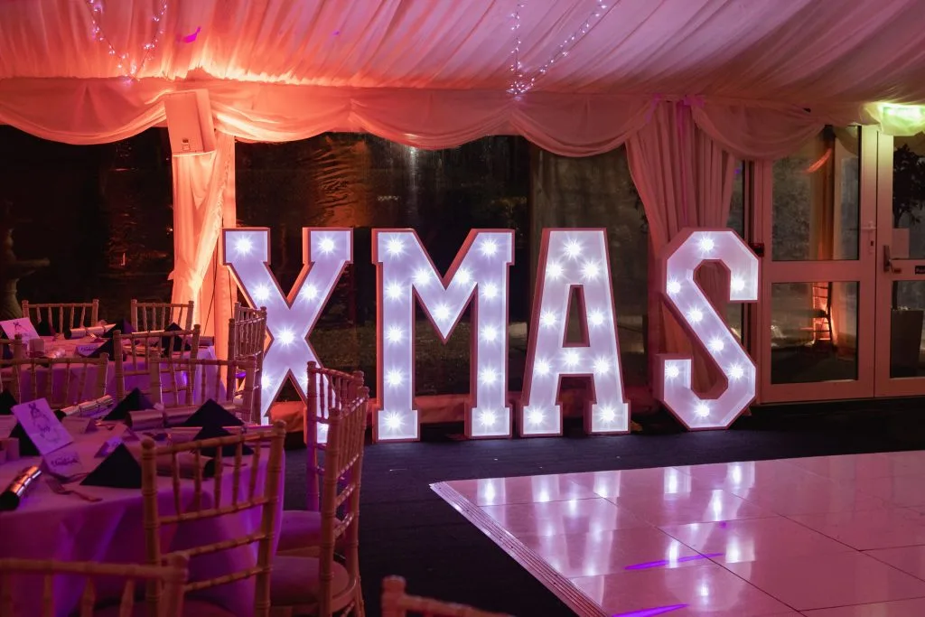 Christmas party sign in marquee with dancefloor at festive event venue in Shropshire, perfect for corporate Christmas parties at The Shropshire