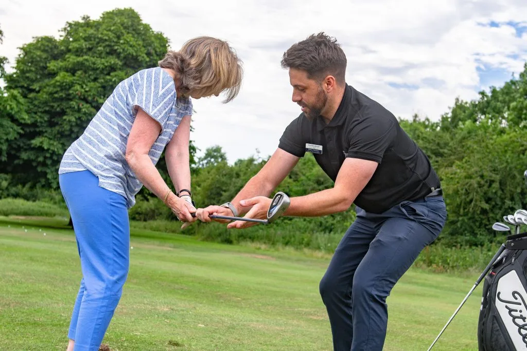 Woman receiving a golf lesson at The Shropshire Golf Club in Telford, benefiting from expert golf coaching and beginner golf lessons in Telford